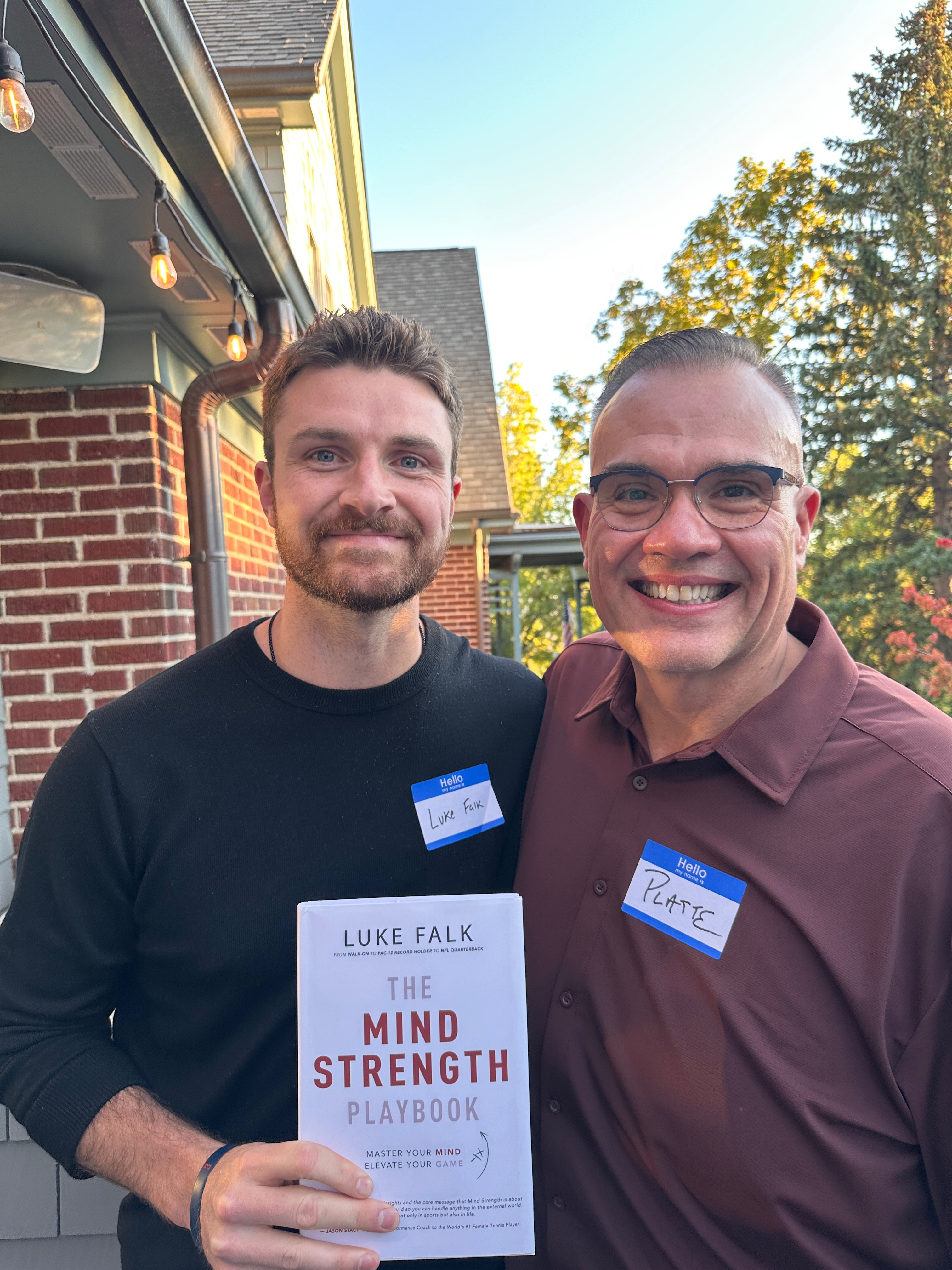 Luke Falk holding The Mind Strength Playbook